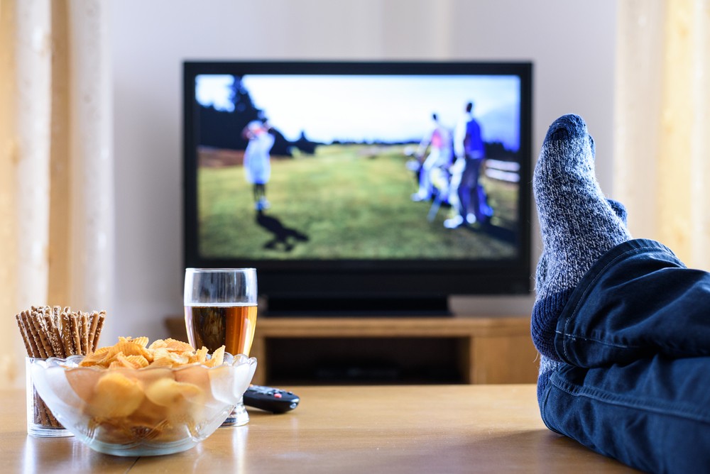 television tv watching golf game with feet